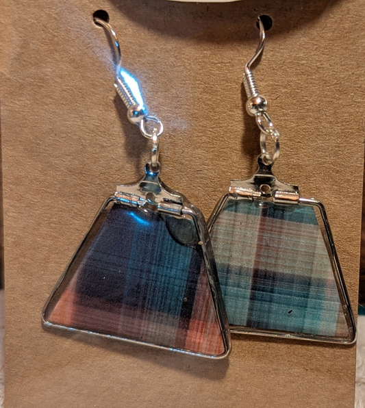 Plaid patterned earrings on a brown background