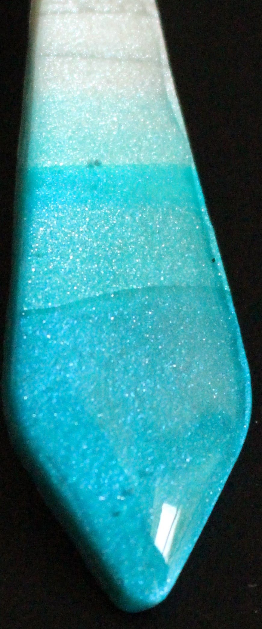 Blue and white striped object on a black background