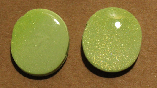 Pair of green round earrings on a brown card